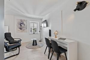 a living room with a desk and chairs at Hotel Stay Properties in Luxembourg +28 photos