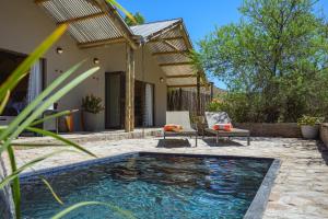 a swimming pool in the backyard of a house at Glen Harry Game Reserve in Graaff-Reinet