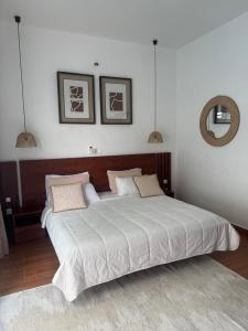 a bedroom with a large white bed with two pillows at Dream Assinie V in Mafia