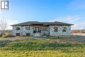 a large stone house with a large yard at Quarto Gananoque #1 in Gananoque