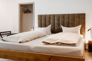 a bedroom with a large bed with a wooden headboard at KleineAuszeit in Blankenburg