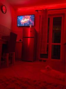 a red room with a refrigerator and a tv at Lina in Dobrota