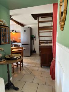 a kitchen with a table and a refrigerator at A Casuccia Sischese in Sisco