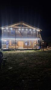 a house is lit up at night with lights at Sarag in Ushguli +7 photos