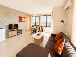 a living room with a couch and a table at Stefaniya Apartments in Sozopol