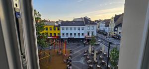 a view from a window of a city street with cars at Drei Schweizer Hotel in Neuwied