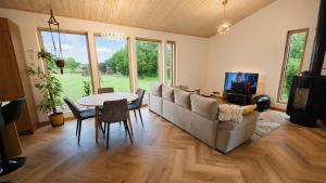 a living room with a couch and a table at Kaasaegne puhkemaja in Kersalu