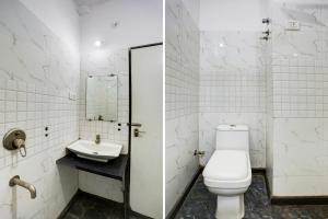 a white bathroom with a toilet and a sink at FabHotel Saanvi Paradise in Bhopal +22 photos