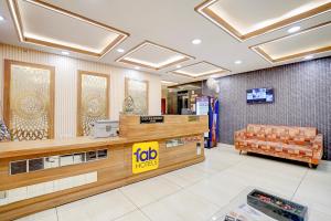 a loblaws store with a couch in the lobby at FabHotel Saanvi Paradise in Bhopal