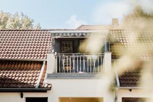 a dog sitting on a balcony of a house at KleineAuszeit in Blankenburg