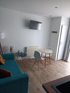 a living room with a couch and a table at Studio agréable in Le Havre