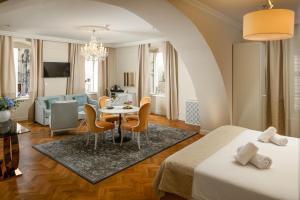 a hotel room with a bed and a dining room at Heritage hotel Santa Lucia in Split