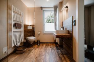 a bathroom with a sink and a toilet and a window at KleineAuszeit in Blankenburg +28 photos
