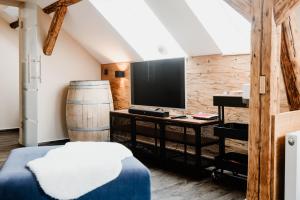 a bedroom with a bed and a television and a barrel at KleineAuszeit in Blankenburg