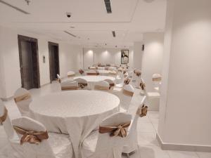 a large room with white tables and white chairs at فندق بشاير الإجابة Bashaier Al EJaba Hotel in Mecca