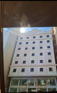 a large white building with a window in front of it at فندق بشاير الإجابة Bashaier Al EJaba Hotel in Mecca