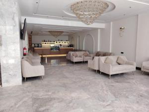 a living room with couches and a chandelier at فندق بشاير الإجابة Bashaier Al EJaba Hotel in Mecca