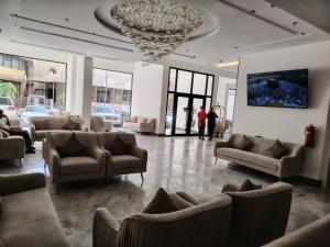 a lobby with couches and chairs and a chandelier at فندق بشاير الإجابة Bashaier Al EJaba Hotel in Mecca
