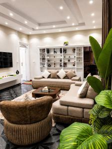 a living room with two couches and a table at Tahrir Residence -"Marriage Certificate Required for Couples" in Cairo