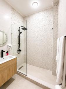 a bathroom with a glass shower and a sink at Tahrir Residence -"Marriage Certificate Required for Couples" in Cairo +22 photos