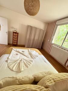 a large bed in a room with a window at Casascope in Jaunay-Clan
