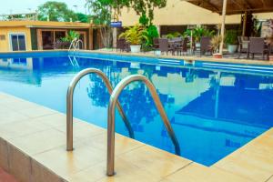 a swimming pool at a hotel with blue water at Ivy Hotel Lagos Ikeja in Hausa +46 photos