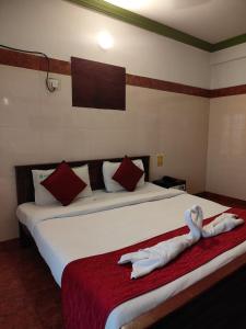 a hotel room with a bed with a towel on it at Klite stays - ZomoHotels in Pondicherry