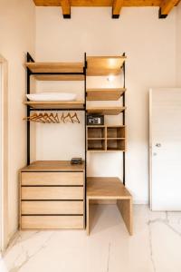 a closet with wooden shelves and a refrigerator at Casa Madrigale - radici e ritorni in Praia a Mare