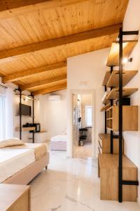 a bedroom with two beds and a wooden ceiling at Casa Madrigale - radici e ritorni in Praia a Mare