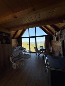 a living room with a couch and a table at Javorje Eco Cabin in Kolašin