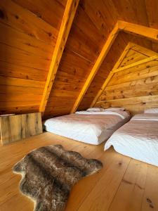 a bedroom with two beds in a wooden attic at Javorje Eco Cabin in Kolašin