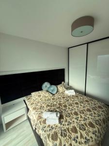 a bedroom with a bed with a comforter on it at RTS Residence in Baia Mare