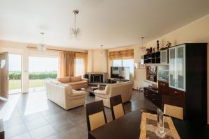 a living room with a couch and a table at Boomerang Villa in Patra