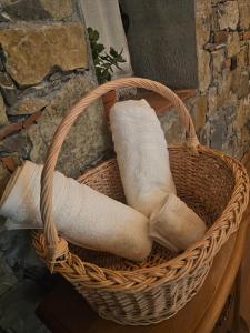 a basket filled with rolled towels on a table at Kulla Zefit Agritourism in Hajmel