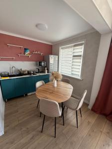 a dining room with a wooden table and chairs at Апартаменты в центре in Balqash