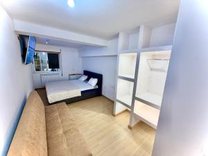 a bedroom with a bed and a bunk bed at Estúdio com cozinha e casa de banho! in Bragança