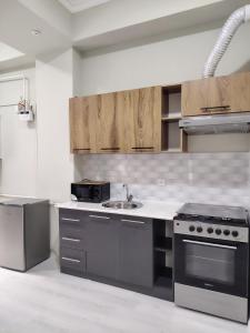 a kitchen with a stove and a sink at Парк апарт-отел in Namangan