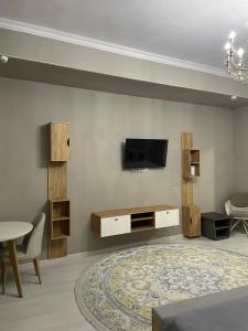 a living room with a tv on a wall at Парк апарт-отел in Namangan