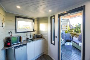 a kitchen with a sink and a door to a patio at Studio room with amazing views in Abersoch