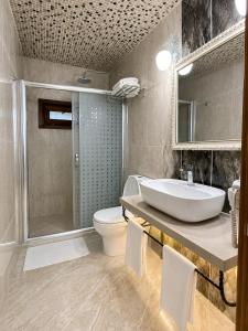 a bathroom with a sink and a toilet and a shower at Motto Polonezköy in Beykoz +84 photos