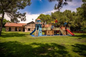 a playground with a slide in a yard at Ali Bey Club & Park in Kizilagac