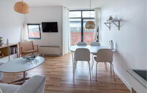 a kitchen and dining room with a table and chairs at Fanø Bad, Lejl 56 in Fanø