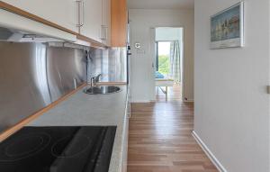 a kitchen with a sink and a counter top at Fanø Bad, Lejl 56 in Fanø