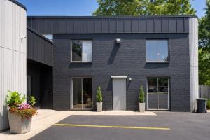a black brick house with a lot of windows at Spacious Private Queen Studio Near Downtown in Muskegon