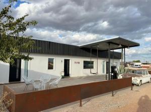 a gas station with chairs and a car parked in front at Pik Pak in Marfa