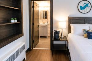 a bedroom with a bed and a sink in a room at Cozy Updated Queen Ground Floor Studio in Muskegon