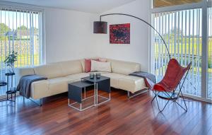 a living room with a couch and a table and chairs at Awesome Home In Otterup With Wifi in Otterup