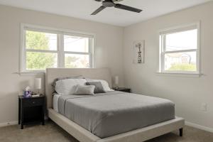 a bedroom with a bed with a ceiling fan at New! Cozy Family Getaway: Amish Farmland|Patio|Washer & Dryer|Central Lancaster County in Ronks