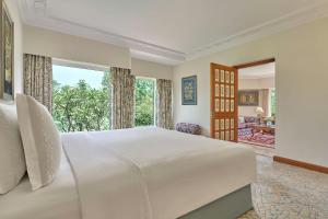 a bedroom with a large bed and a large window at ITC Mughal, A Luxury Collection Resort & Spa, Agra in Agra +58 photos