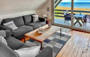 a living room with a couch and a table at Awesome Home In Haderslev With Wifi in Haderslev